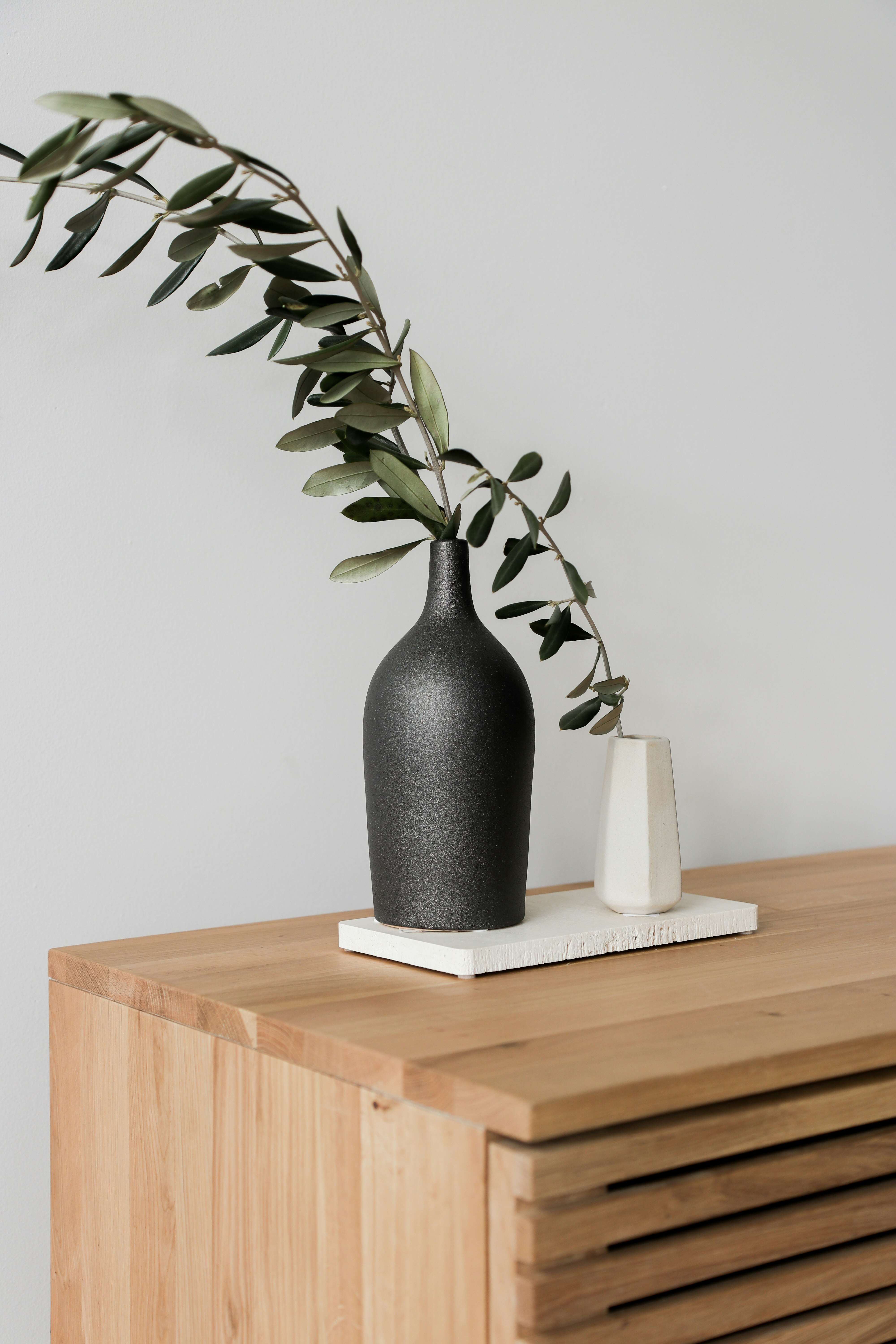 black ceramic vase on brown wooden table